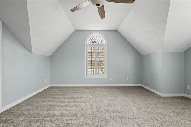 additional living space featuring baseboards, carpet, a ceiling fan, and vaulted ceiling