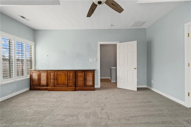 unfurnished bedroom with ceiling fan, carpet, visible vents, and baseboards