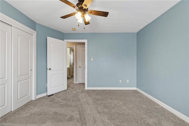 unfurnished bedroom with a closet, a ceiling fan, baseboards, and carpet floors