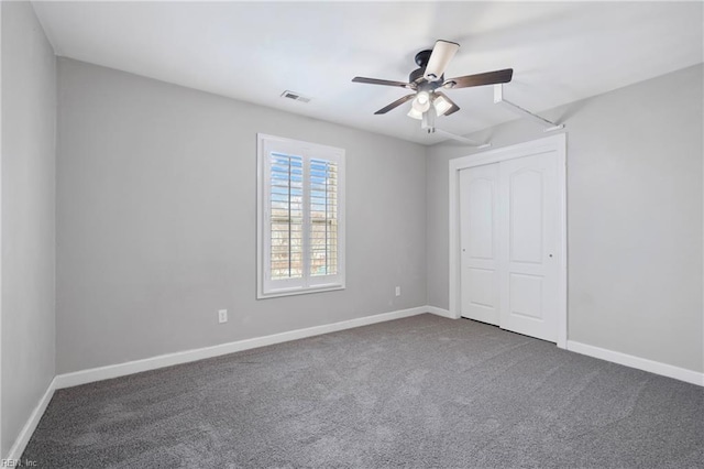 unfurnished bedroom with visible vents, carpet, baseboards, a closet, and a ceiling fan