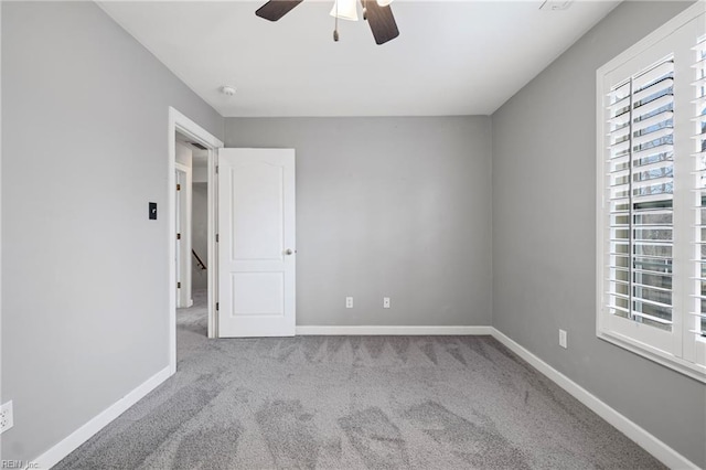 unfurnished bedroom featuring baseboards, carpet floors, and a ceiling fan