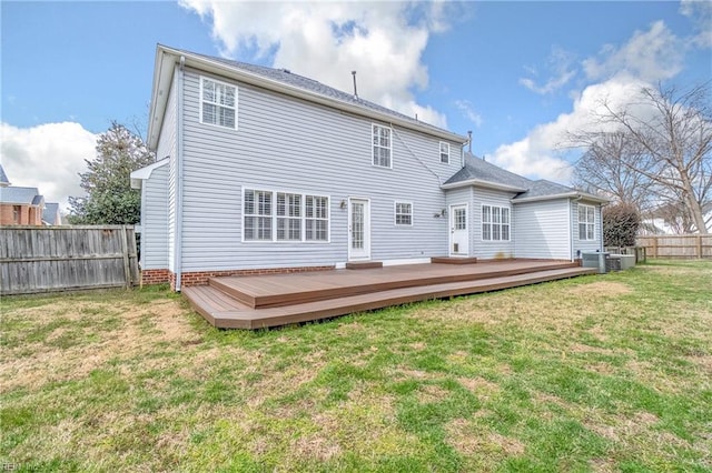 rear view of house with a yard, cooling unit, a wooden deck, and a fenced backyard