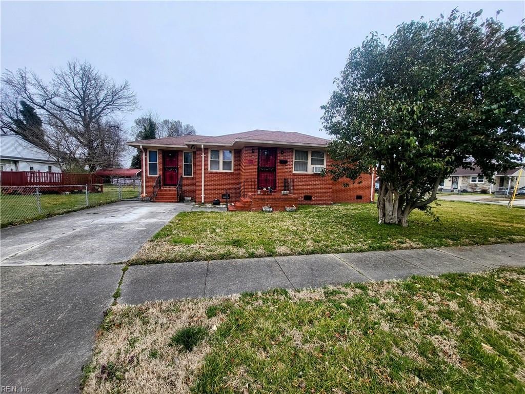 single story home featuring fence, driveway, a front lawn, crawl space, and brick siding