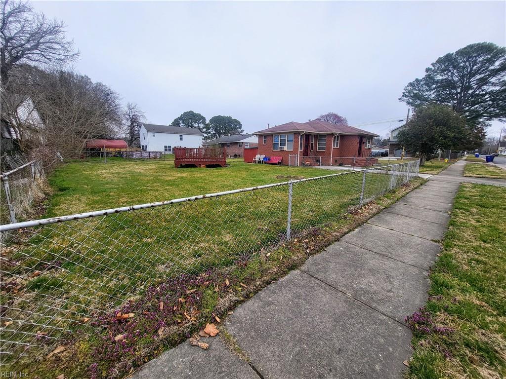 view of yard with a wooden deck and a fenced backyard