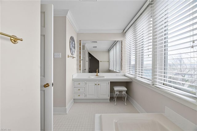 bathroom with tile patterned floors, baseboards, vanity, and crown molding