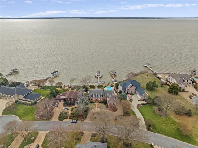 drone / aerial view featuring a residential view and a water view