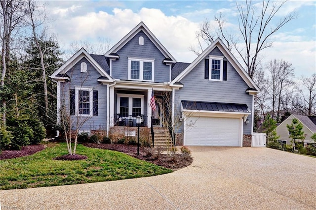 craftsman-style house with a porch, driveway, and an attached garage