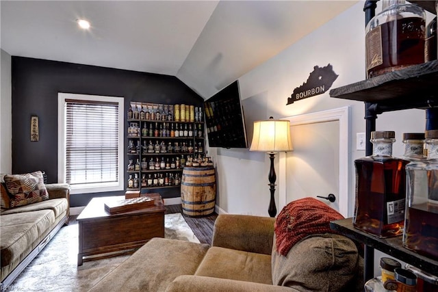 living area featuring a bar and lofted ceiling