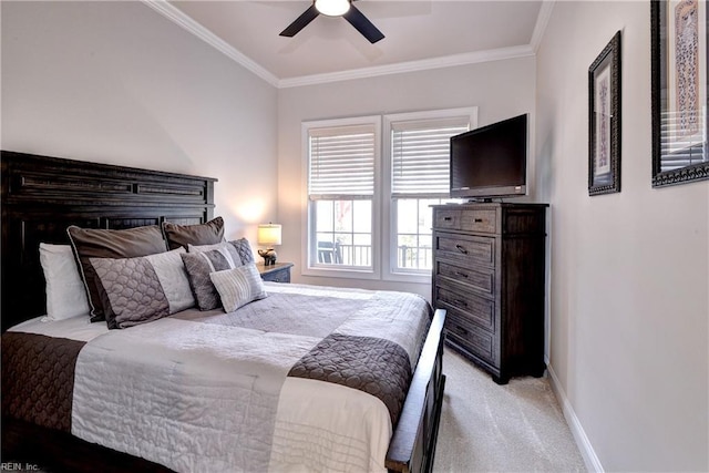 bedroom featuring ornamental molding, a ceiling fan, baseboards, and light carpet