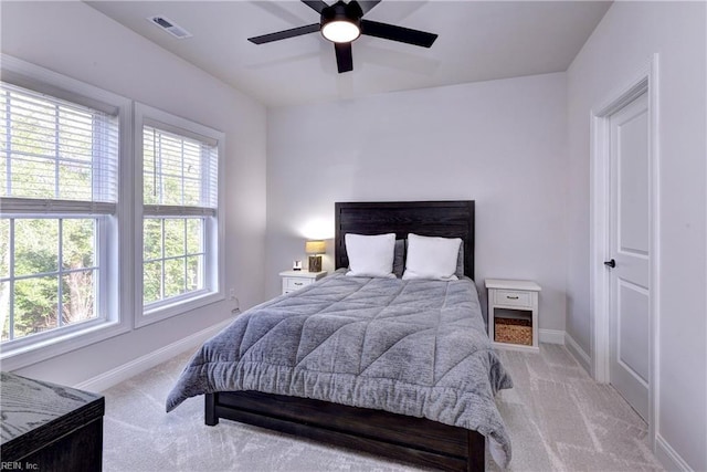 bedroom featuring baseboards, visible vents, and light carpet