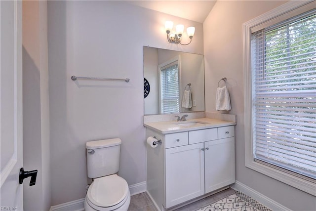 half bath with tile patterned floors, baseboards, toilet, and vanity