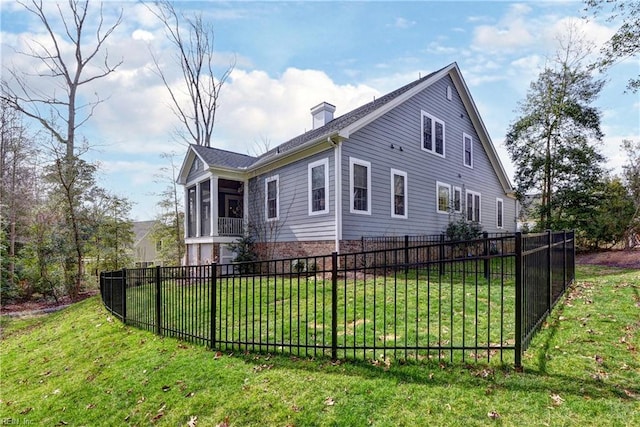 view of side of home featuring a yard, fence private yard, and a chimney