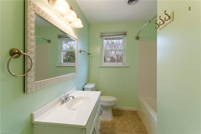 full bathroom featuring baseboards, toilet, bathing tub / shower combination, tile patterned floors, and vanity