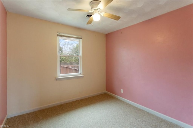 empty room with baseboards, carpet floors, and a ceiling fan