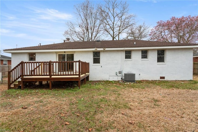 rear view of property with brick siding, crawl space, a lawn, and a wooden deck