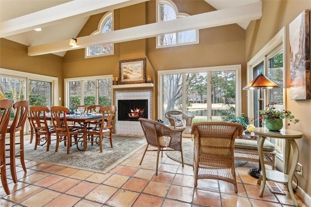 sunroom / solarium featuring a large fireplace and lofted ceiling with beams