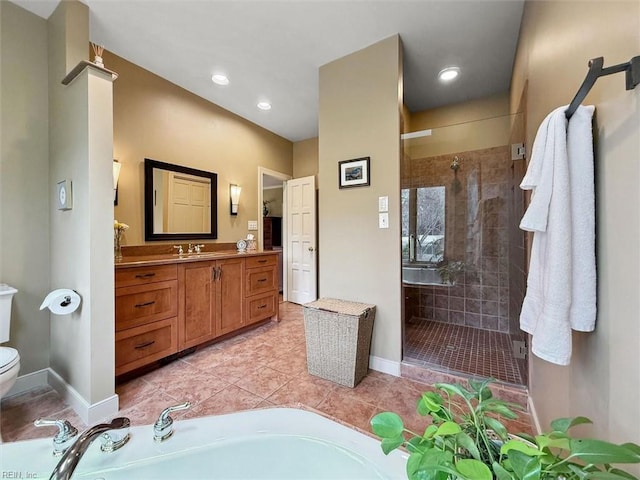 bathroom with baseboards, toilet, a garden tub, a stall shower, and vanity