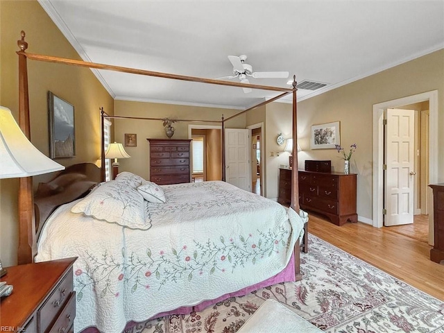 bedroom with visible vents, a ceiling fan, crown molding, light wood finished floors, and baseboards