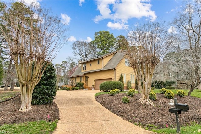 view of front of property featuring concrete driveway and an attached garage