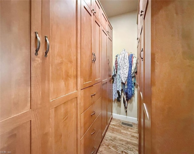 hall with visible vents and light wood-style flooring