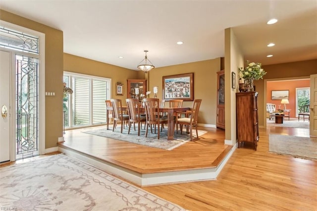 dining space with recessed lighting, baseboards, and light wood finished floors