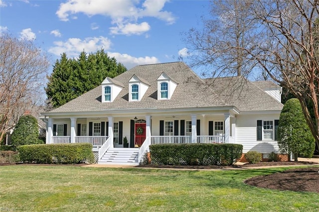 cape cod-style house featuring roof with shingles, covered porch, and a front lawn