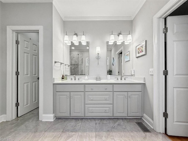 bathroom featuring ornamental molding, a walk in shower, visible vents, and a sink