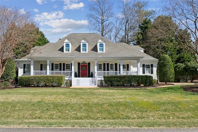 cape cod home with roof with shingles, covered porch, and a front yard