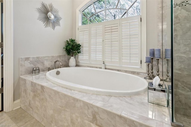 bathroom featuring a bath and tile patterned flooring