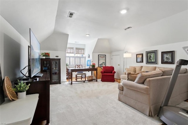 living area featuring lofted ceiling, carpet flooring, and visible vents