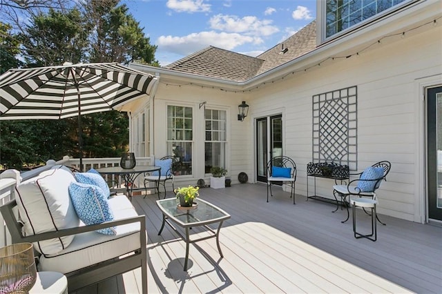 wooden terrace featuring outdoor dining space and outdoor lounge area