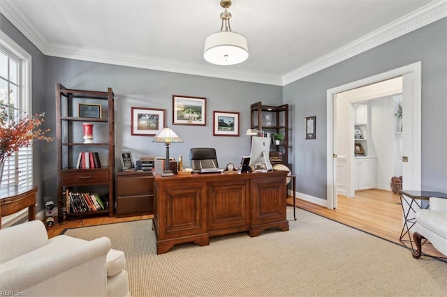 home office with crown molding, light wood-style floors, and baseboards