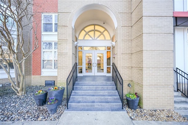 property entrance with french doors and brick siding