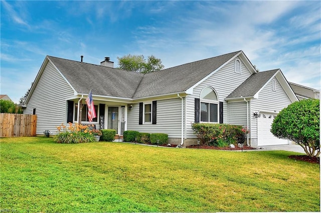 view of front of property featuring a front lawn, a chimney, an attached garage, and fence