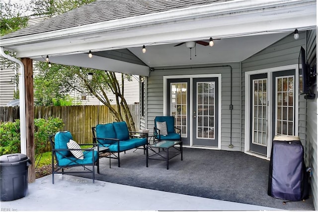 view of patio featuring ceiling fan and fence