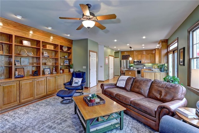 living room with recessed lighting, a ceiling fan, and light wood-type flooring