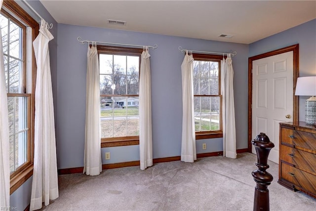 unfurnished bedroom with visible vents, baseboards, and carpet