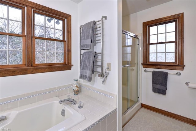 bathroom with radiator, baseboards, a garden tub, and a stall shower