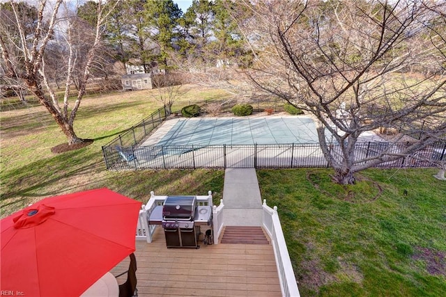 view of pool featuring a lawn, a grill, a fenced in pool, and fence