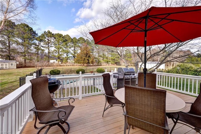 deck featuring outdoor dining area, a fenced in pool, grilling area, and fence