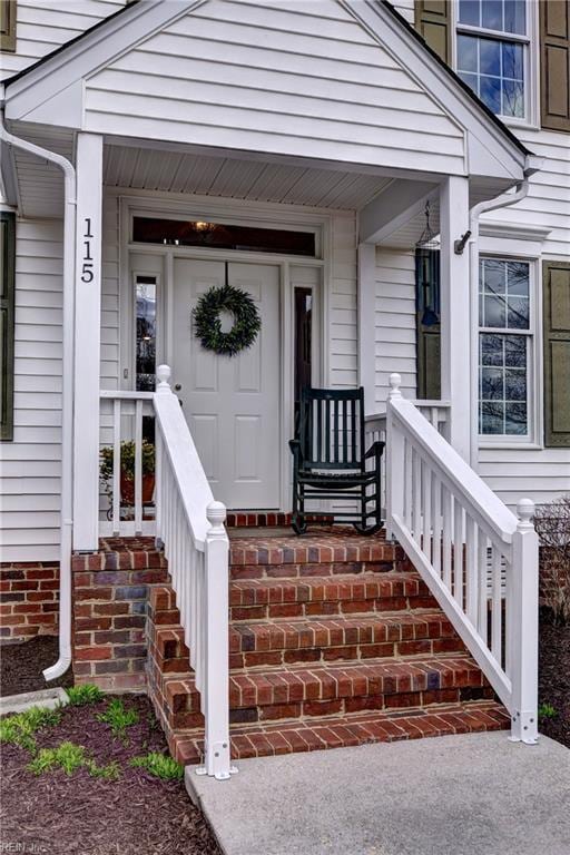 view of exterior entry featuring covered porch