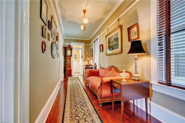 interior space featuring crown molding, wood finished floors, and baseboards