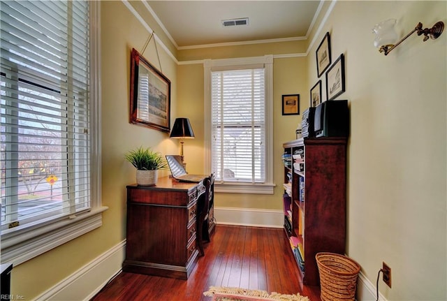 home office with visible vents, dark wood-type flooring, baseboards, and ornamental molding