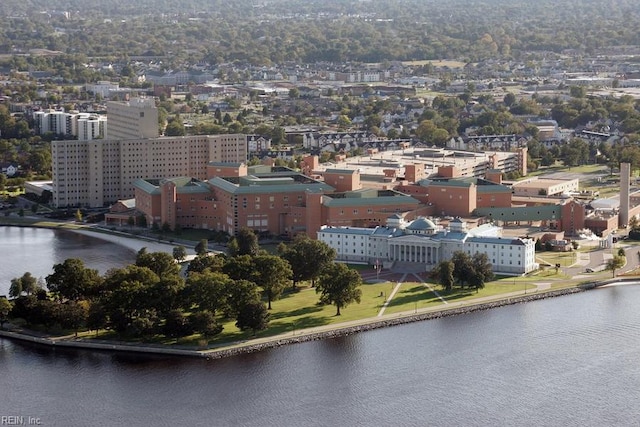 birds eye view of property featuring a city view and a water view