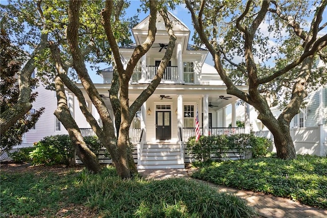 neoclassical home featuring a balcony, covered porch, and ceiling fan