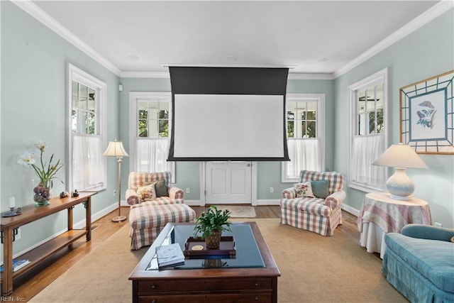 living room featuring wood finished floors, a healthy amount of sunlight, and ornamental molding