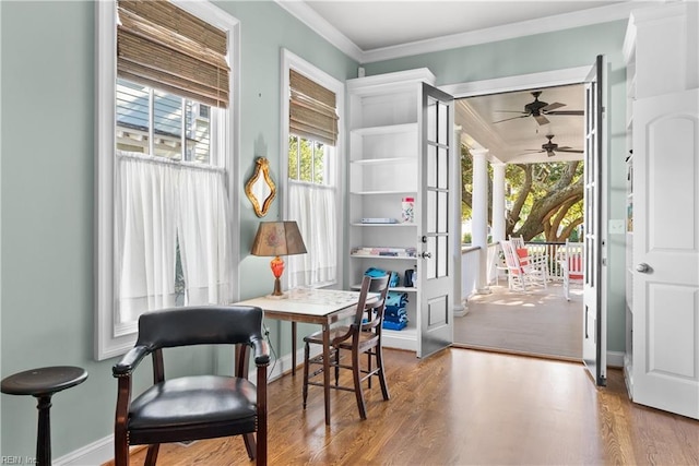 entryway with baseboards, wood finished floors, a ceiling fan, and ornamental molding