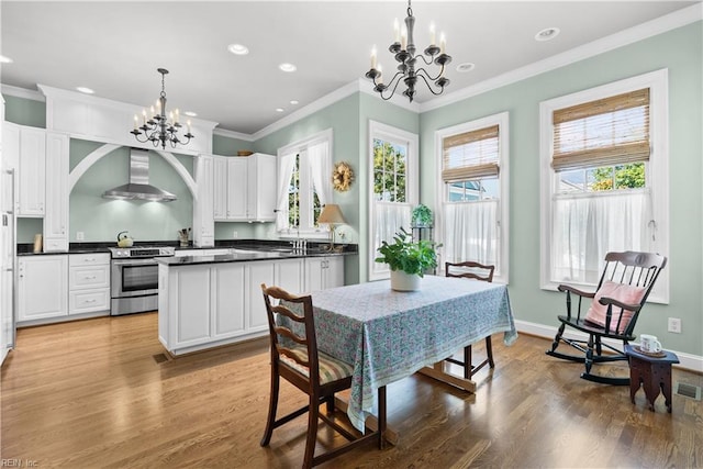 dining area with recessed lighting, a notable chandelier, baseboards, and light wood-type flooring