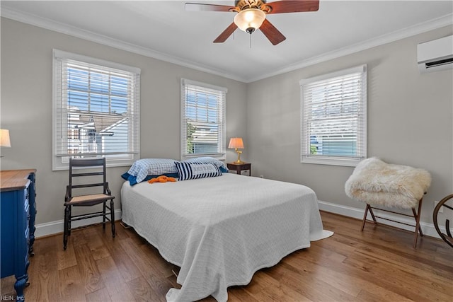 bedroom featuring an AC wall unit, crown molding, and wood finished floors