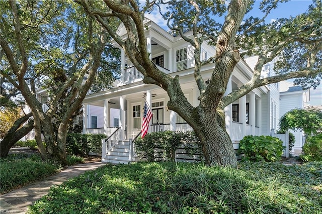 view of front facade featuring a porch, a balcony, and ceiling fan